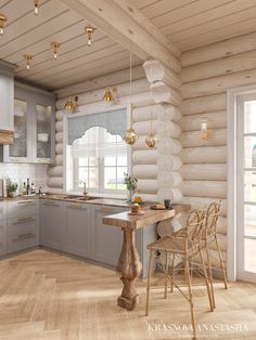 the interior of a log cabin kitchen with wood flooring and white walls, along with an island