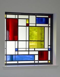 a stained glass window in the corner of a room