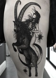 a woman riding on the back of a black and white goat with stars around her