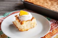 a piece of cake sitting on top of a white plate next to a baking pan