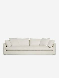 a white couch with pillows on it