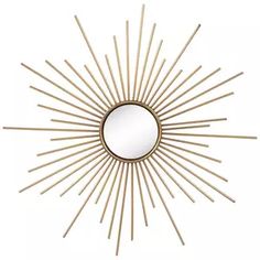 a gold sunburst mirror on a white wall