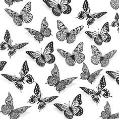 black and white butterflies flying in the air with their wings spread out to form a pattern