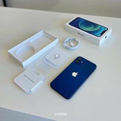 an apple iphone is sitting on a table next to its box and packaging material,