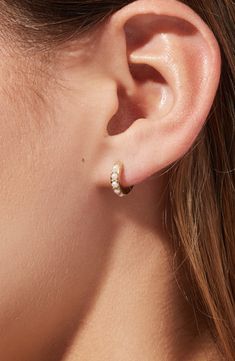 Featuring lustrous Swarovski pearls in a pavé setting, these elegant pearl huggie hoops are this season’s must-have. Carefully crafted in 100% recycled Sterling Silver and dipped in 14k gold, these pearl huggie hoops will add a dainty vibe to any outfit. Recycled Sterling Silver huggies with a thick 14k gold coating Feature perfect Swarovski pearls in a pavé setting Comfortable to wear & hypoallergenic Width:11.6mm - 0.5" Depth: 1.9mm - 0.1" Weight: 1g Hoop Diameter: 11.6mm - 0.5" Post: Stainles Wedding Earrings Rose Gold, Double Piercing Wedding Earrings, Every Day Earrings, Pearl Earrings Wedding The Bride, Pearl Stud Earrings Simple, Simple Drop Earrings, Gold Dainty Earrings, Dainty Pearl Jewelry, One Ear Piercing