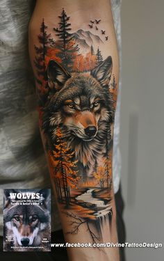 a man's arm with a wolf and forest scene on it, next to a book