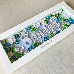 a white frame with flowers and the word sending on it