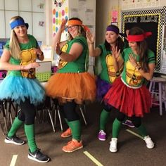 four girls dressed in teenage mutant costumes and tutus, one girl is waving at the camera