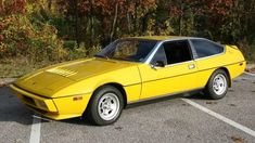 a yellow sports car parked in a parking lot