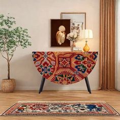 a living room with a rug, table and pictures on the wall