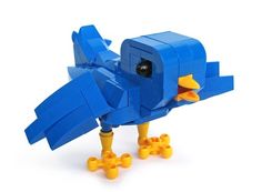 a toy blue bird with yellow feet and wings