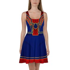 a woman wearing a blue dress with red, yellow and blue stripes on the chest