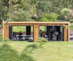 an outdoor gym in the middle of a field with trees and grass behind it on a sunny day