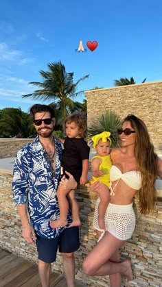 a man and woman with two children posing for a photo