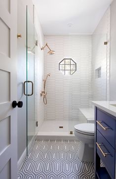 a white and blue bathroom with an open shower