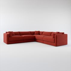 a red sectional couch sitting on top of a white floor