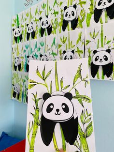 there are pandas on the wall and one is holding up a piece of paper