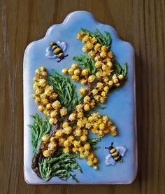 a blue plate with yellow flowers and bees on it