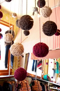 several balls of yarn hanging from the ceiling