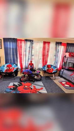 a spider man themed bedroom with red and blue curtains