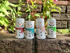 three toilet paper roll snowmen sitting next to each other