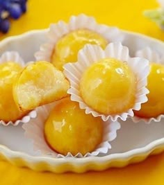 some lemons are sitting in small white bowls