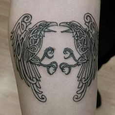 an angel tattoo on the leg of a person's arm with two hands touching each other