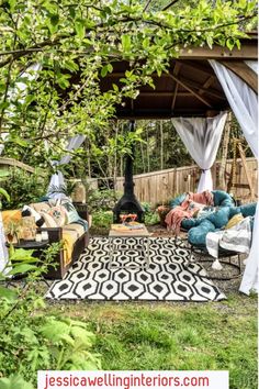 an outdoor living area with furniture and curtains