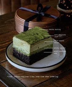 a piece of cake sitting on top of a white plate next to a brown box