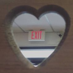 an exit sign in the shape of a heart