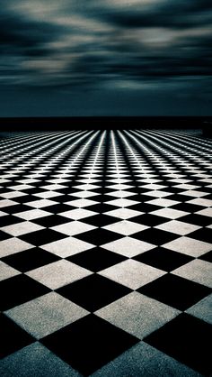 an abstract black and white checkered floor with dark clouds in the sky above it