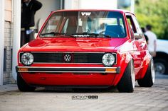 a red car parked in front of a building