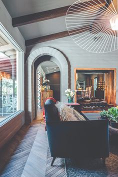 a living room filled with furniture and lots of windows