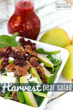 a salad in a bowl with apples, pears and cranberries on the side