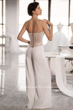 Elevate your bridal look with our stunning two-piece set. The shimmering beaded lace corset top boasts delicate hand-sewn flowers and beadwork, while the chiffon pants add flow and elegance. Complete with a lace-up closure, it's perfect for a modern and charming bridal ensemble. shown color: nude top+white pants with build-in bra top back lace-up pants side zipper top without lining pants fully lined Wedding Corset With Delicate Lace, Elegant Lace Bodice With Corset Back, Elegant Lace Corset For Wedding Night, Elegant Lace Wedding Corset, Elegant Lace Wedding Night Corset, Elegant Corset With Sweetheart Neckline And Delicate Lace, Elegant White Lace Bodice, Elegant Lace Corset With Delicate Detail, Wedding Lace Corset With Lace Bodice