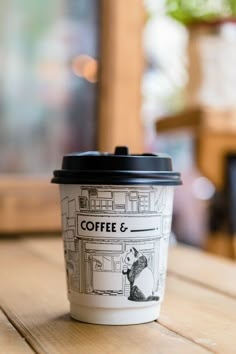 a coffee cup sitting on top of a wooden table