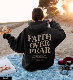 "Faith Over Fear Christian Hoodie 👉 QUICK FACTS 👈 50% cotton/ 50% polyester fabric blend Runs true to size. If you would like an oversized fit, be sure to order 1-3 sizes up. 👉HOW TO ORDER:👈 1. Please, Check and Review all Photos. 2. Select Your Size and Color from drop down menus. 3. Choose Your Quantity as much as you want. 4. Click \"Add To Cart\". For multiple items go back to the listing and repeat the steps. 👉Sizing Chart 👈 Use the sizing chart to understand the measurement of our Ho Faith > Fear, Chique Outfit, Christian Hoodies, Psalm 118, Ayat Alkitab, Aesthetic Hoodie, Christian Sweatshirt, Long Sleeve Tops Casual, Faith Over Fear