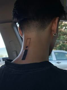 the back of a woman's head with a tattoo on her left side of her neck