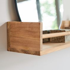 a wooden shelf with a mirror on it