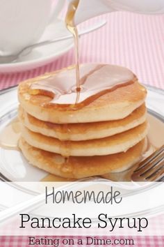 a stack of pancakes with syrup being poured on top