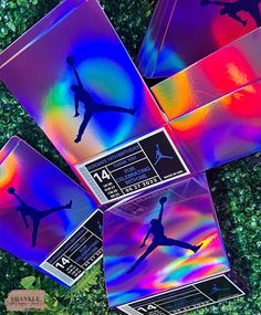 four different colored air jordan coasters sitting on top of grass