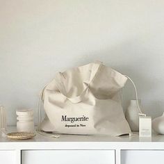 a bag sitting on top of a white shelf