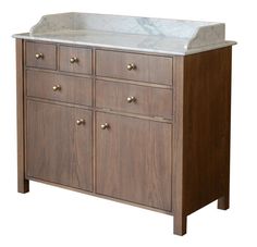 a bathroom vanity with marble top and wooden cabinetry on the bottom, against a white background