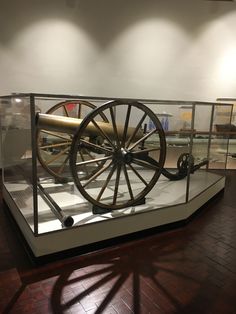 an old cannon on display in a glass case