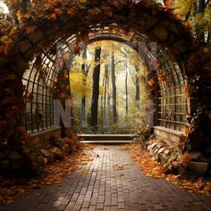 an arch in the middle of a brick walkway surrounded by trees and leaves with fall colors