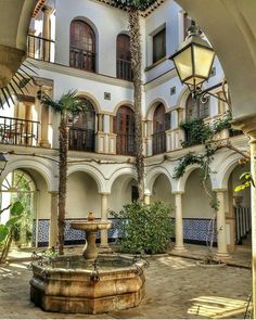 an old building with a fountain in the courtyard