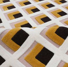 a yellow and black rug with squares on it