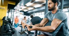 a man is sitting on a bench in the gym