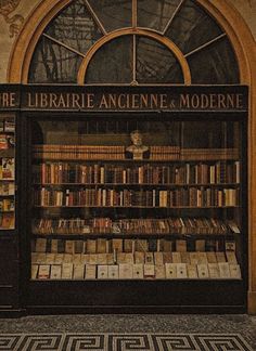 an old library with many books on display in front of a arched window that reads, the library anciente & moderne