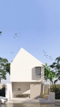 a white house sitting on top of a cement floor